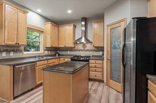 The kitchen features beautiful natural woodwork and stainless steel appliances.