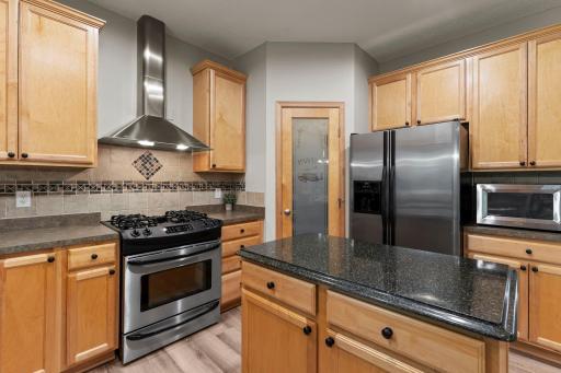 The kitchen features beautiful natural woodwork and stainless steel appliances.