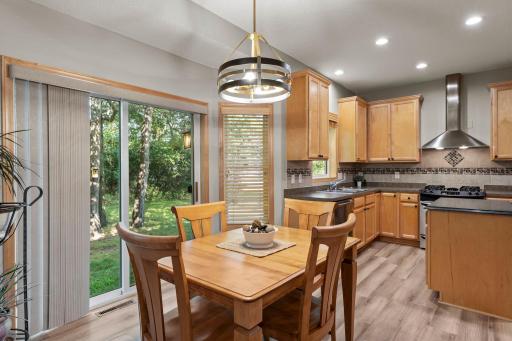 The dining room overlooks the wooded backyard.