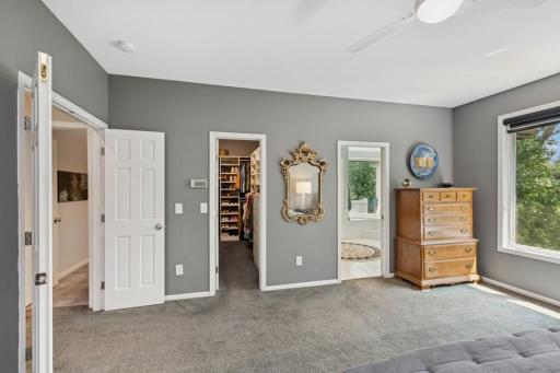 Primary bedroom includes large walk in closet with custom organization and ensuite bath