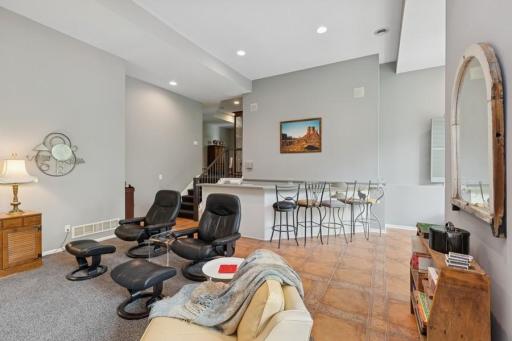 Step down the stairs to the walkout family/entertainment room