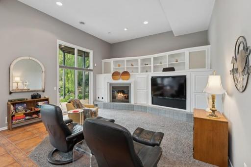 Soaring ceilings and media wall with storage and gas burning fireplace