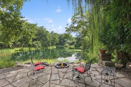 Paver patio and firepit overlooking the pond