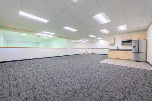The upstairs features an open mezzanine with a viewing area and windows overlooking the racquetball courts.