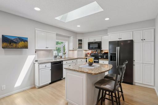 Center island kitchen with custom cabinets & pull outs.
