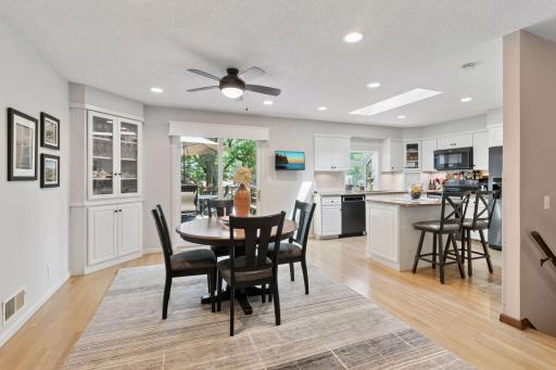 Open Kitchen / Dining room with thoughtfully stained hardwood floors.