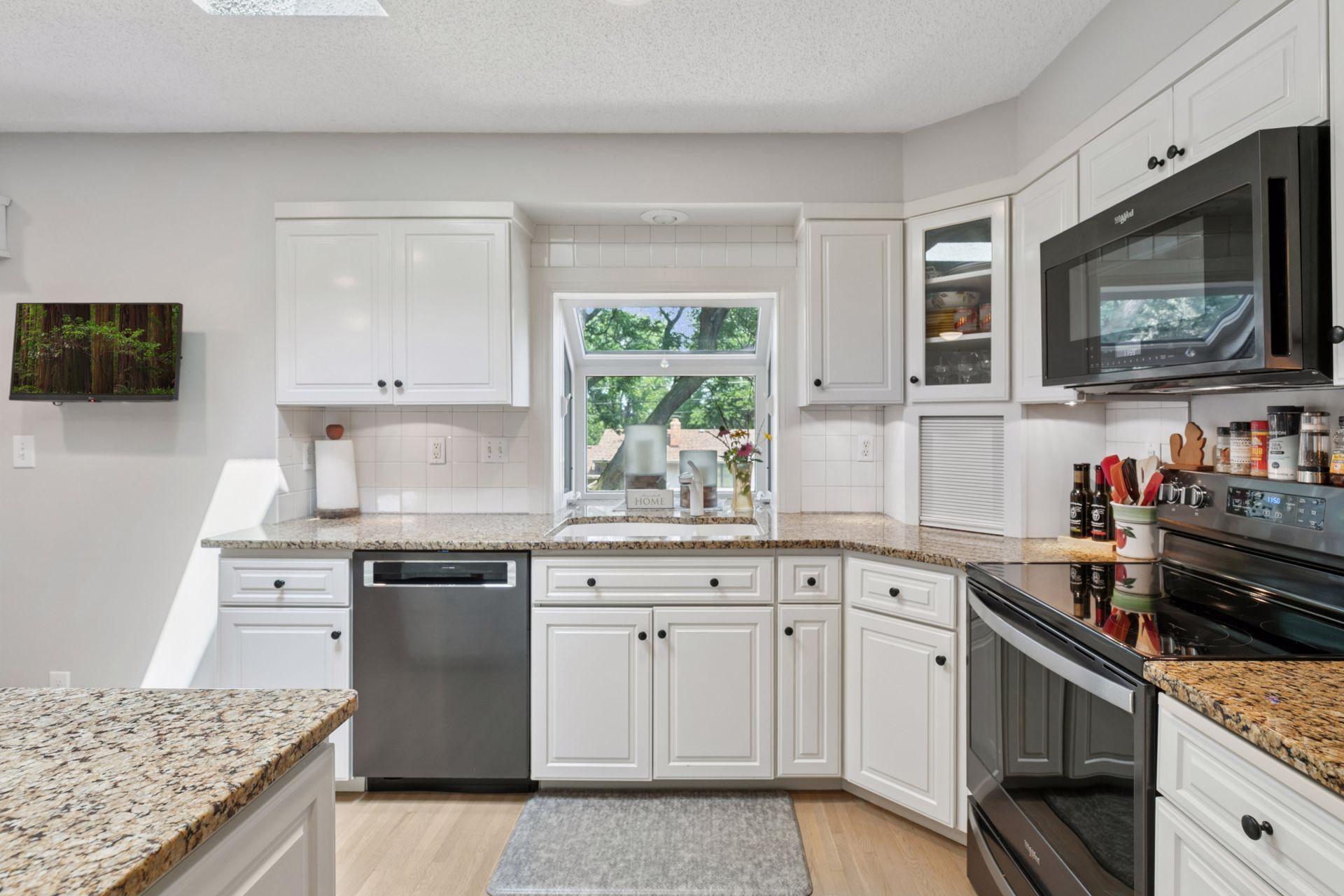 Ample counter space with granite extending into the plant window. Corner appliance "garage" to keep it tidy.