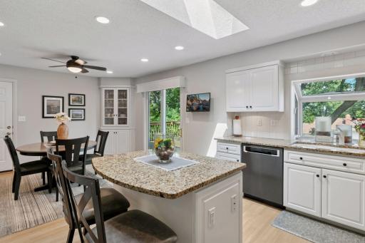 Plant window over kitchen sink and sliding door to deck.