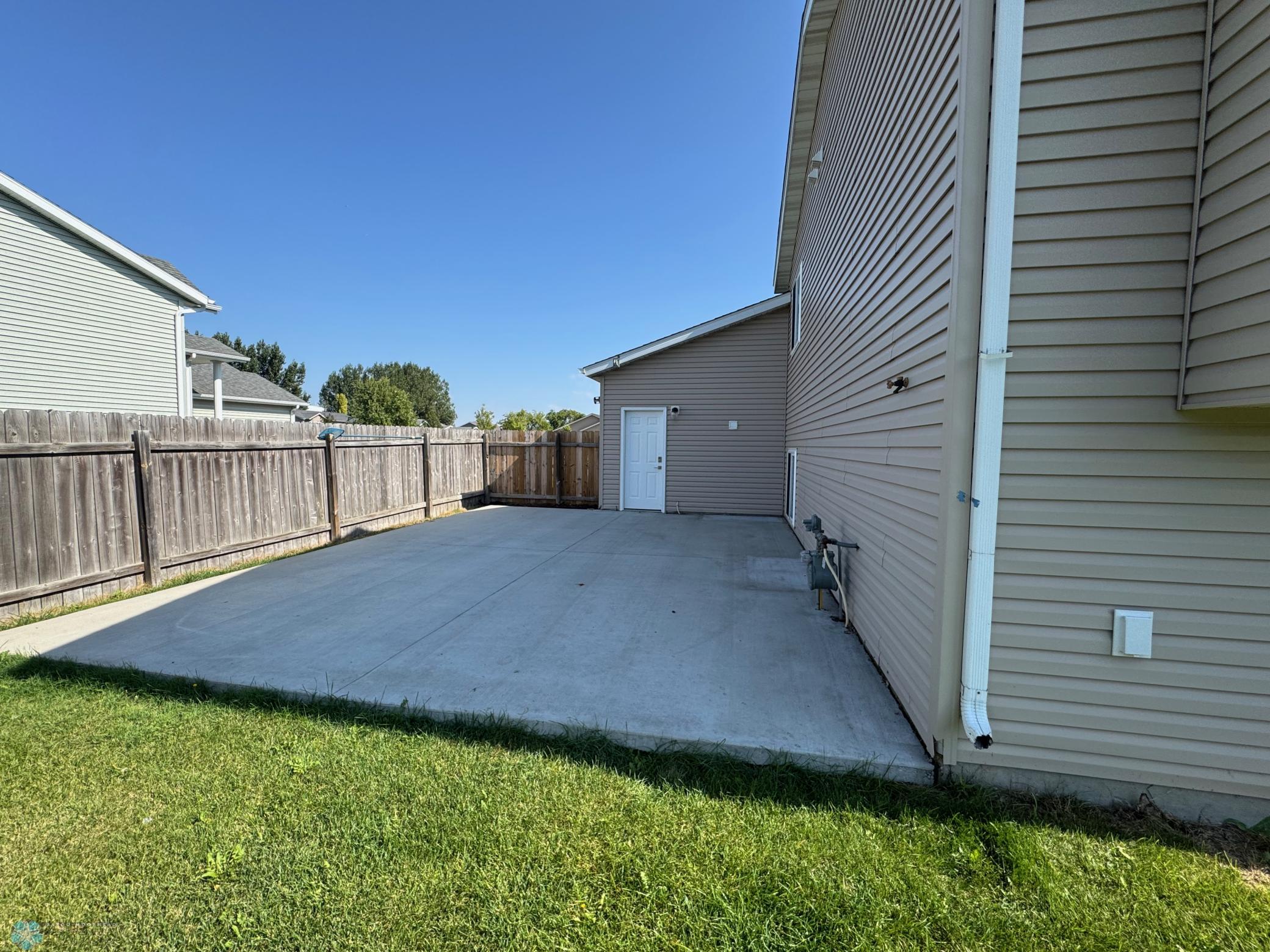 Patio behind garage.