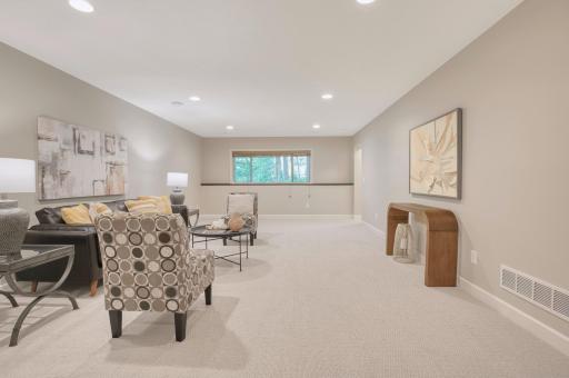 Expansive plush carpet, stair access, and entrance to flex/storage space