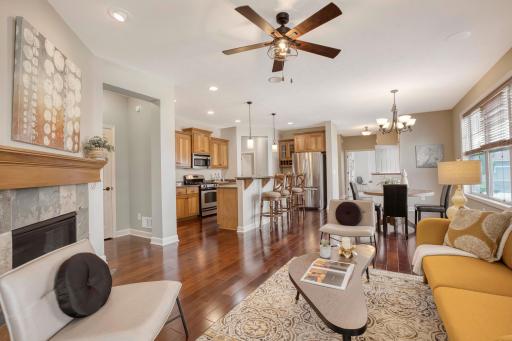 Entertaining main level living room, dining room and kitchen filled with natural light from the surrounding windows.