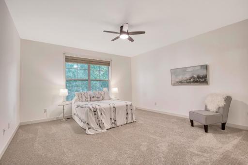 Large and light-filled ownerâs suite with new carpet, oversized window, and modern ceiling fan for added comfort.