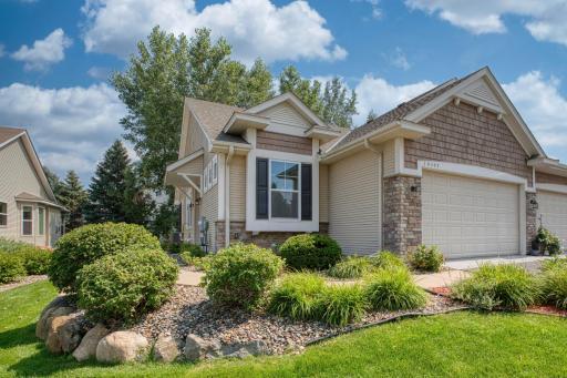 Beautifully maintained exterior with stone accents, charming gables, and meticulous landscaping, creating inviting curb appeal.