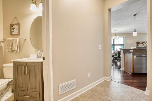 Another angle of the main-level powder room showcasing the neutral color palette, updated lighting, and functional layout perfect for guests.