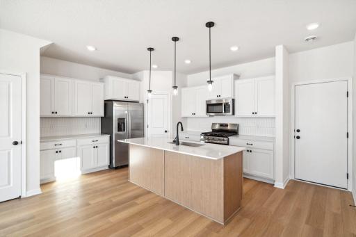 Large Island and plenty of cabinets! Finishes and selections vary