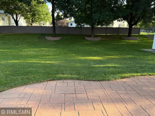Large fenced in back yard with beautiful large stamped concrete patio