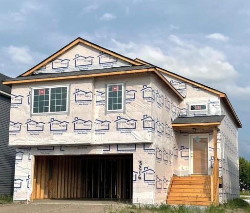 3216 Kady Ave NE- Photo of home under construction offering an estimated October move-in! Siding and stone accents will be installed soon. Highlights include a finished walkout lower level!