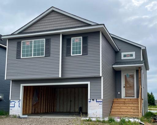 3216 Kady Ave NE- Photo of home under construction offering an estimated October move-in! Stone accents will be installed soon. Highlights include a finished walkout lower level!