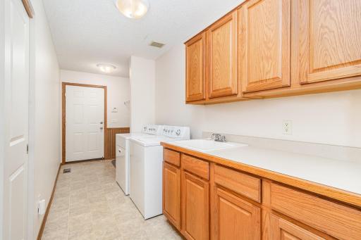 convenient laundry room with full cabinets