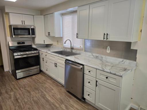 White cabinetry and stainless appliances help make this an inviting space.