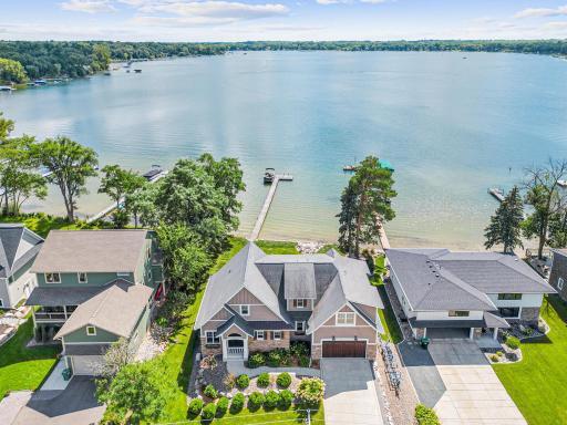 Lake life at its finest! This 5BD/5BA home boasts 90’ of sugar-sand shoreline, incredible curb appeal, open floor plan, and luxurious finishes—seamlessly blending everyday comfort with one of Ramsey County’s most sought-after lakes.