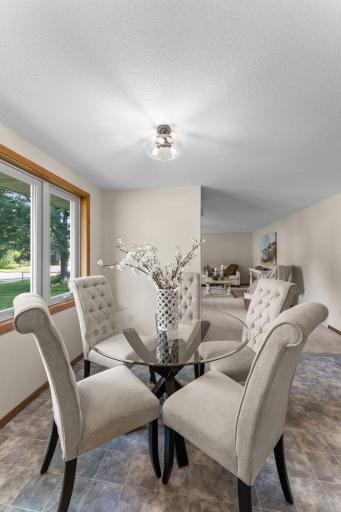 The living room flows easily into the dining area, highlighted by modern lighting (updated 2025) and an airy, inviting feel.