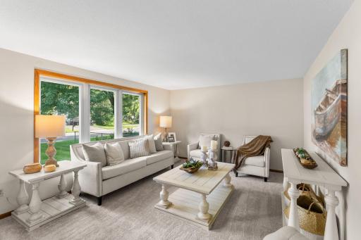 Designed with comfort and everyday functionality in mind, all living spaces are thoughtfully arranged on the main level. Step inside to discover a bright and welcoming living room, where a large front window pours in natural light.