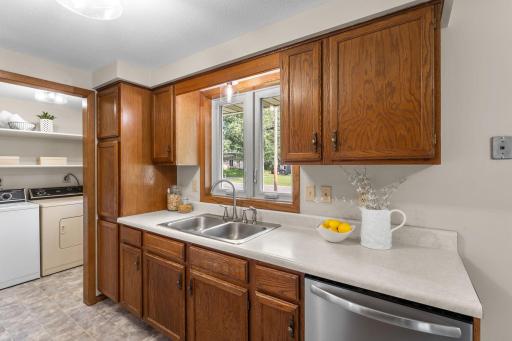 Since it opens to the dining and living rooms, the kitchen keeps you connectedâideal for entertaining. Just beyond is the versatile mudroom and laundry area, complete with shelving, additional closet space and convenient side-door access to the yard.