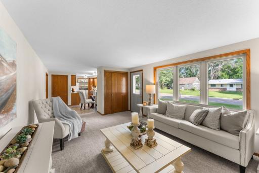 Recent updates, including new carpeting and fresh paint (completed summer 2025), make the space feel fresh and move-in ready. A generously sized coat closet at the entry adds practical storage.