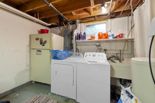 LOWER LEVEL LAUNDRY LOCATED WITHIN LARGE UTILITY/STORAGE ROOM