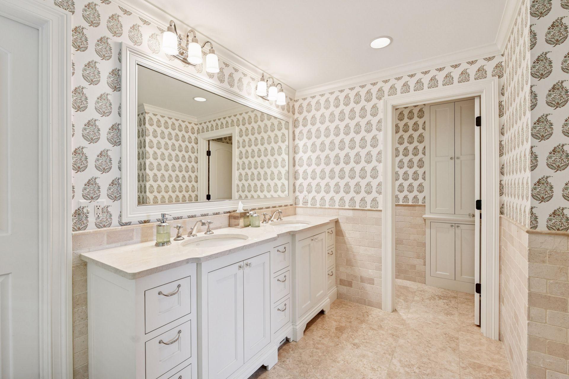 Primary bathroom features double sinks, separate tub and walk-in shower, and a walk-in closet