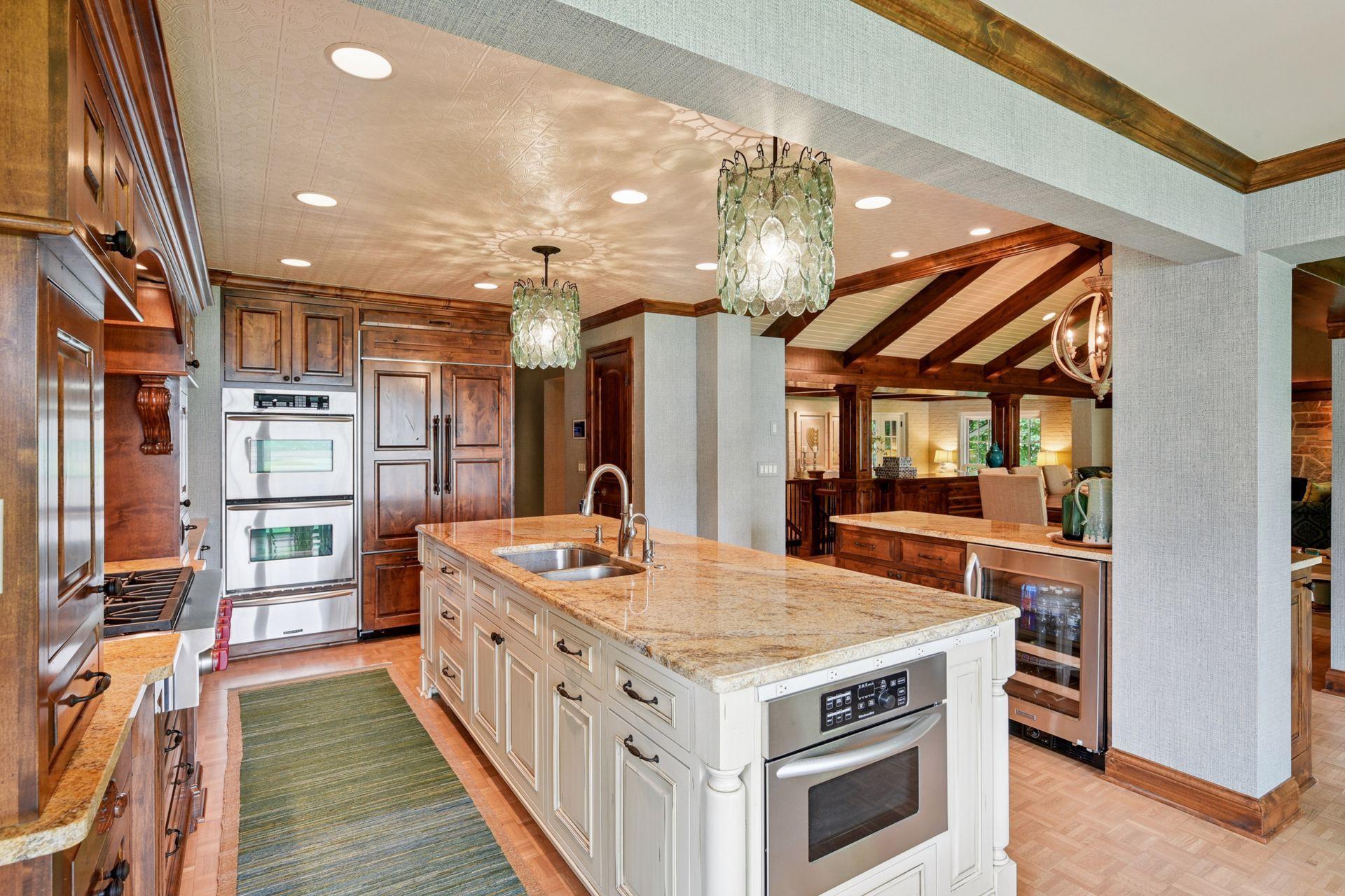 Light-filled kitchen featuring beautiful woodwork, ceiling details, and updated lighting throughout