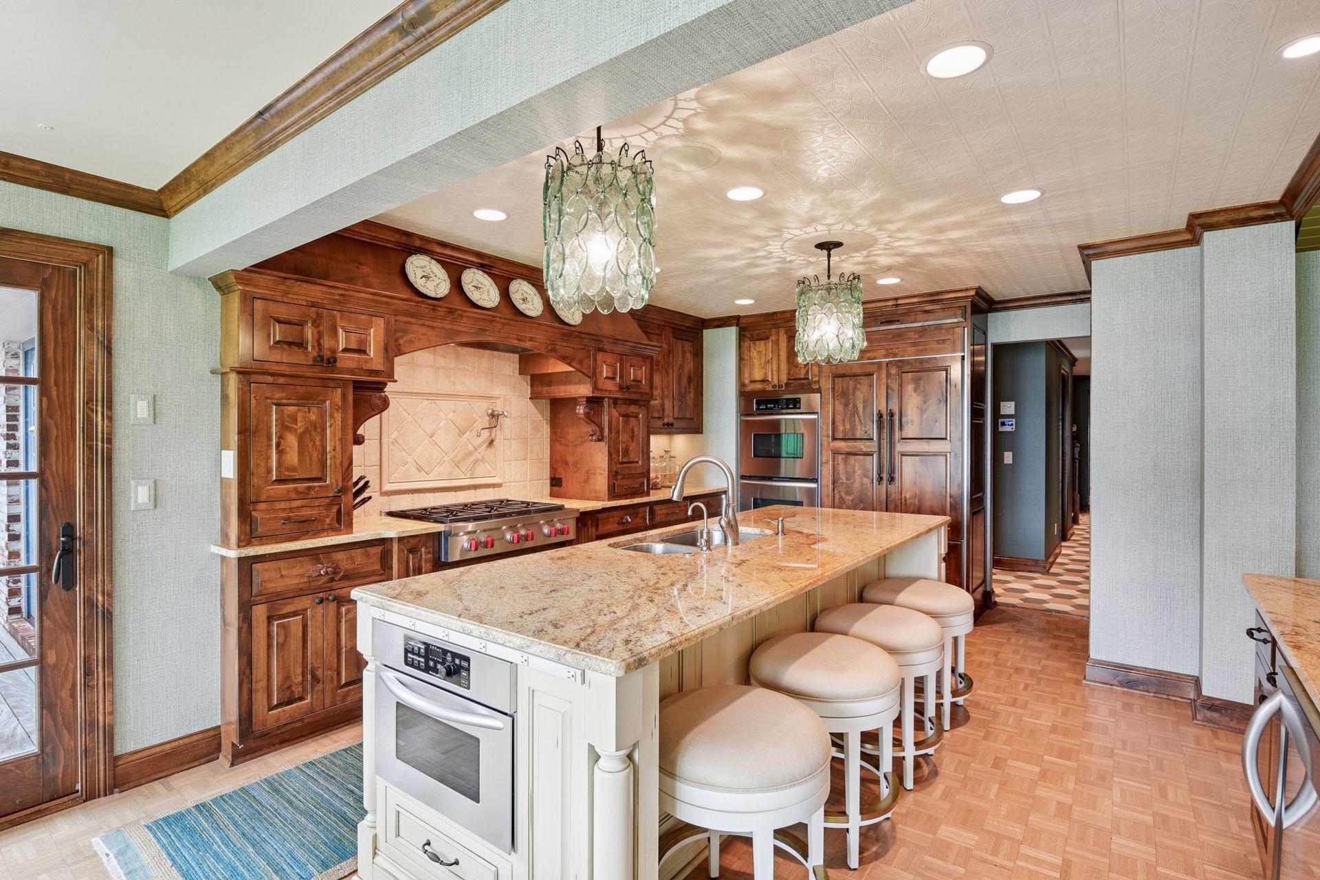 Warm and inviting kitchen with timeless finishes, built-in appliances, and seamless indoor-outdoor flow