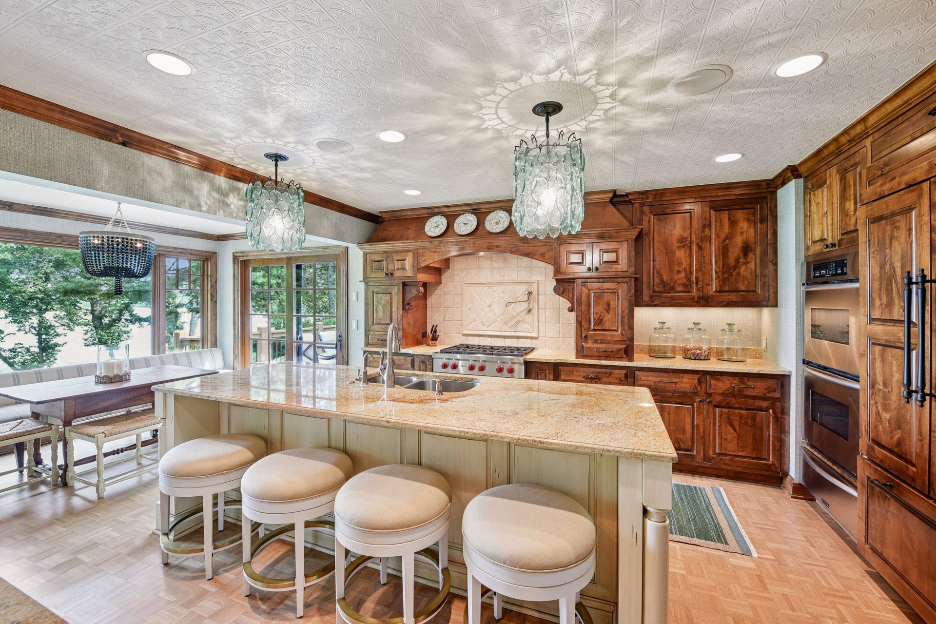Gourmet kitchen with oversized island, custom cabinetry, and high-end appliances - perfect for everyday living and entertaining.