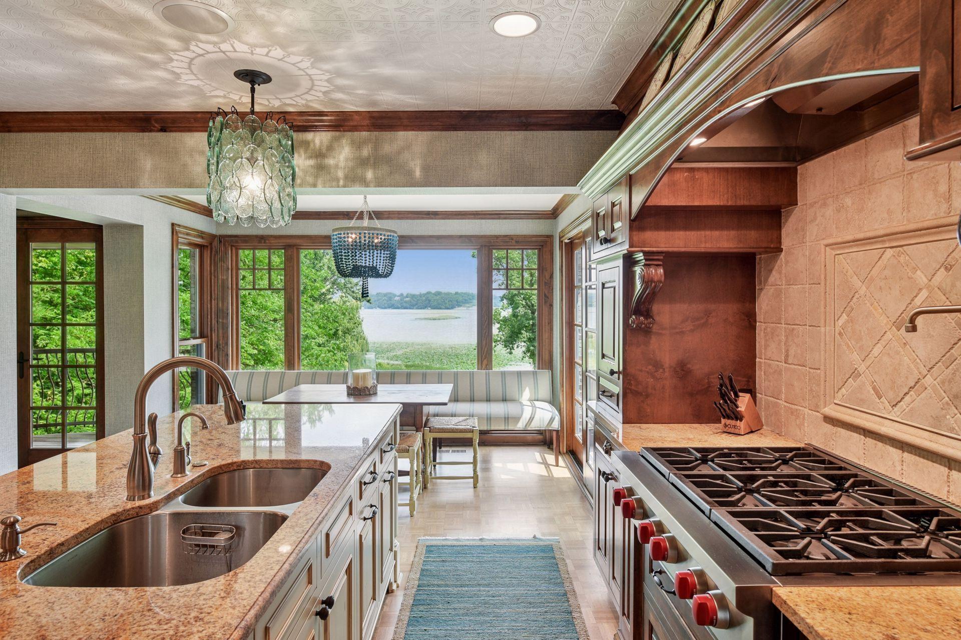 Spacious center island with seating opening to a charming dining nook and scenic backyard views