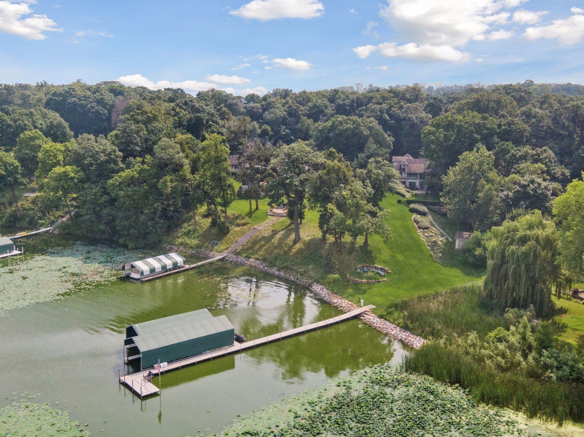 Set on about 2.5 acres of dense woods and sweeping lakeside lawn