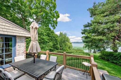 Main floor deck with sweeping views of the yard and lake