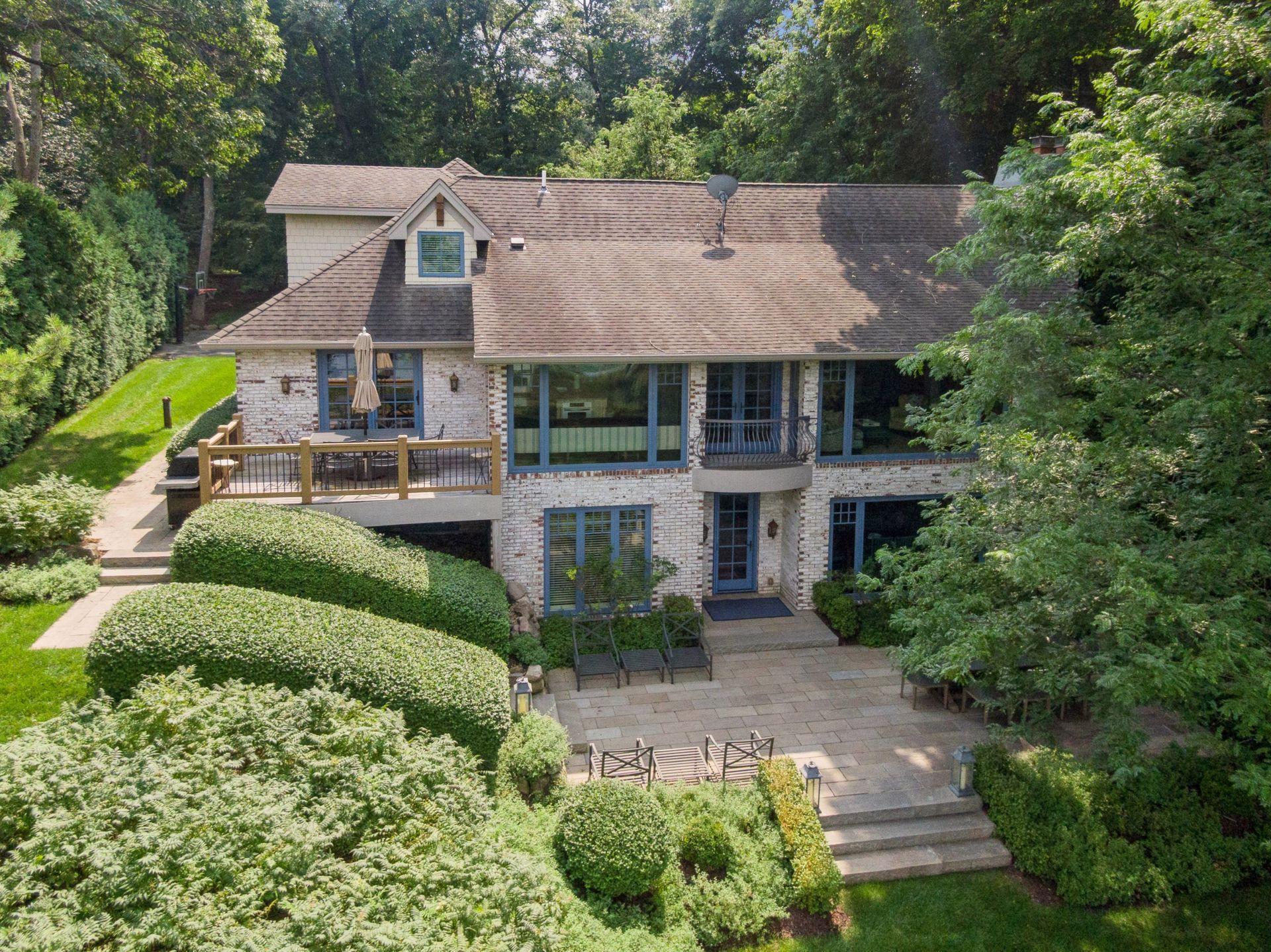 Beautifully landscaped yard with expansive green space and a serene patio perfect for outdoor dining