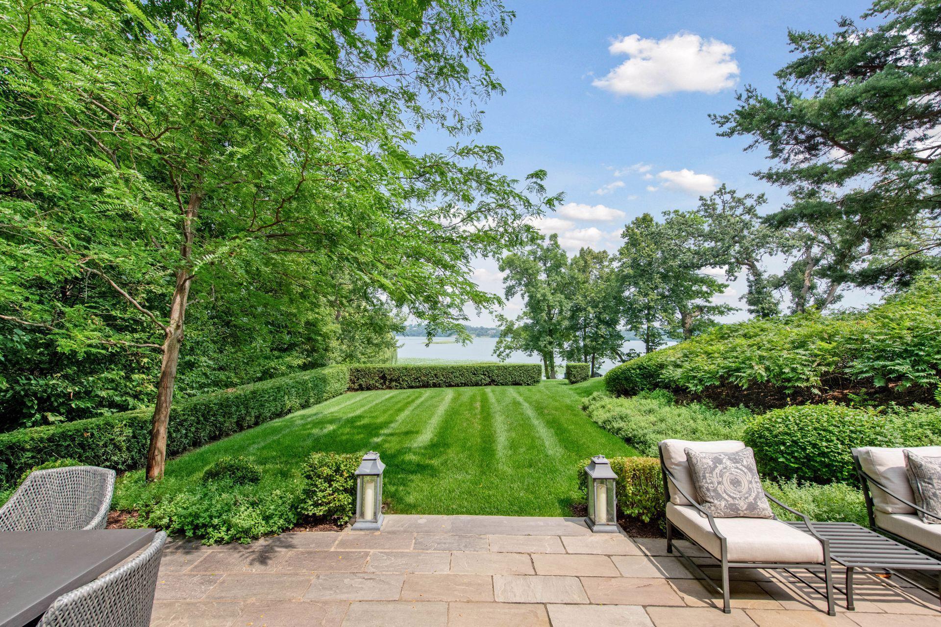 Beautifully landscaped yard with expansive green space