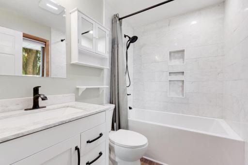 Updated Primary Bathroom with Deep Soaker Tub and Marble Tile