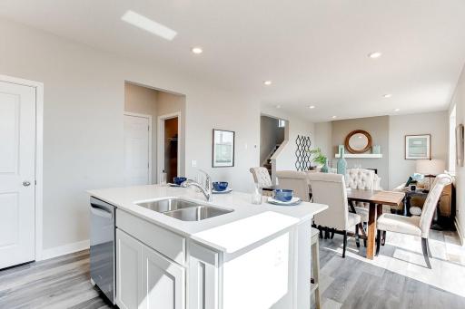 A view of your main floor from the kitchen. Bright, open, and perfect for moving about with ease. Model pictures shown. Colors and finishes may vary.