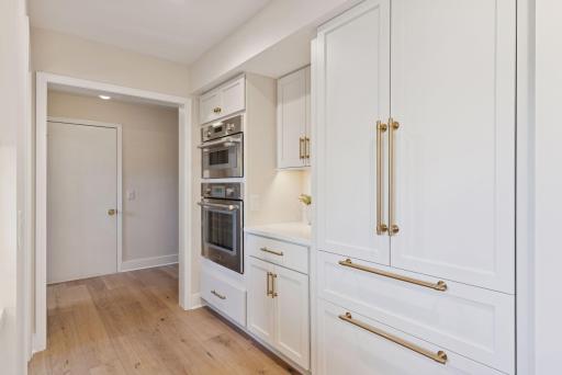 Discover a thoughtfully designed kitchen where the oven and microwave are seamlessly tucked away for an organized and efficient cooking experience.