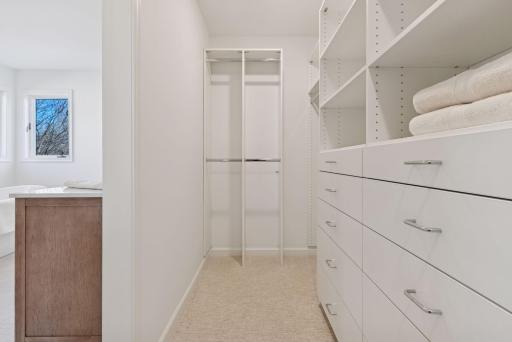 Primary bedroom walk-in closet with built in organizational components