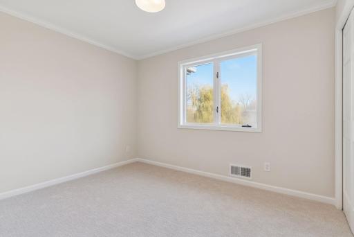 Second bedroom on the upper level with new carpet.