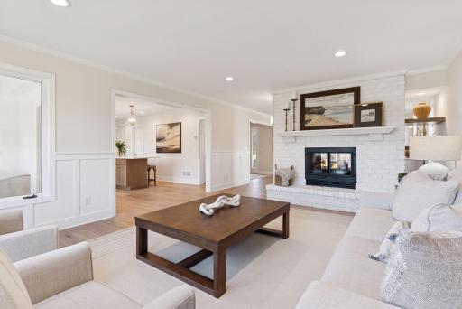 A versatile double-sided wood burning fireplace serves as the centerpiece of this living space, with a gas line added for easy conversion to a gas fireplace.