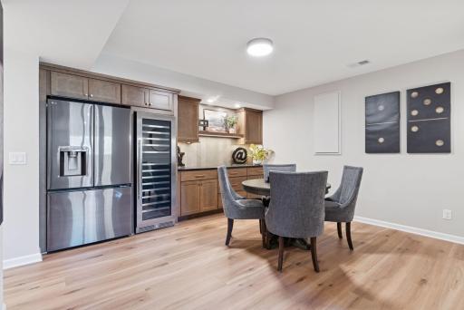 Head to the lower level to discover a fully finished floor, complete with a stylish dry bar, beverage fridge, ample storage space, and plenty of room for a game table