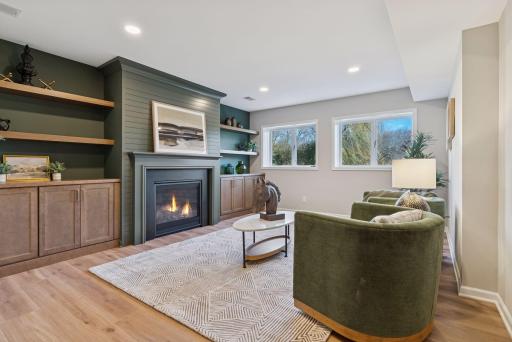 Enjoy the stylish rec room, featuring a cozy gas fireplace, gorgeous built-ins, and elegant white oak flooring, perfect for relaxation and entertainment.