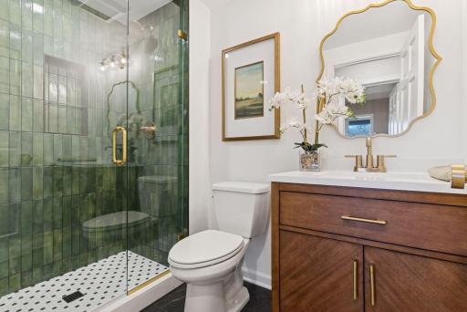 Explore the lower-level 3/4 bathroom, showcasing fabulous tiling, new light fixtures, and newly roughed-in features.