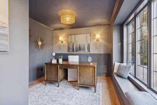 Step into the stunning study, featuring an accent wall, new light fixtures, engineered French Oak floors, and charming window bench seating.