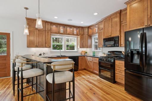 Generous kitchen space with view of backyard